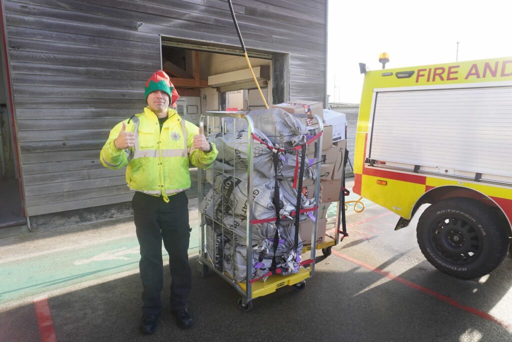 Member of team with trolley full of Royal Mail letters