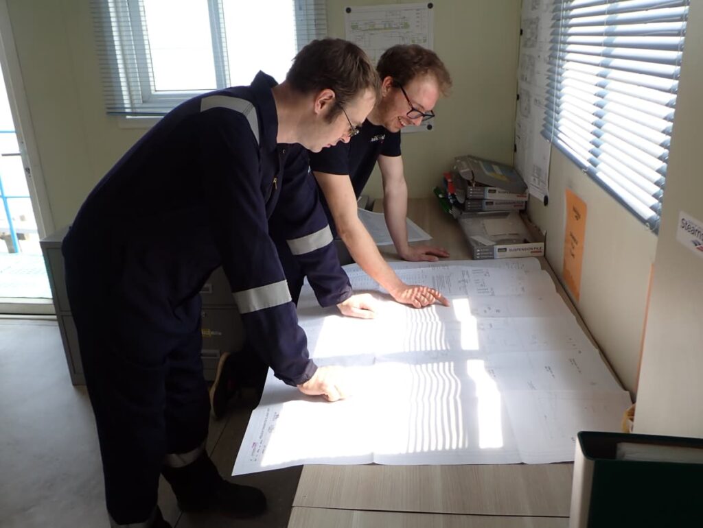 Luke and Tom looking at technical drawings