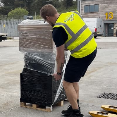 hayle warehouse employee wrapping a pallet of goods
