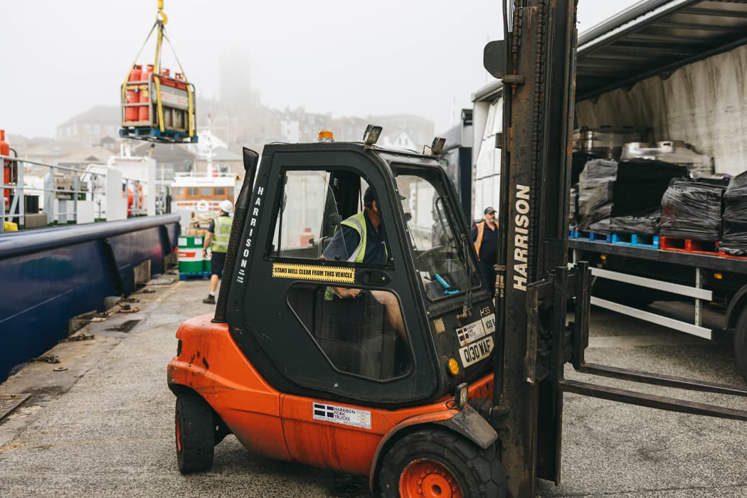 Forklift transporting cargo from lorry to Menawethan