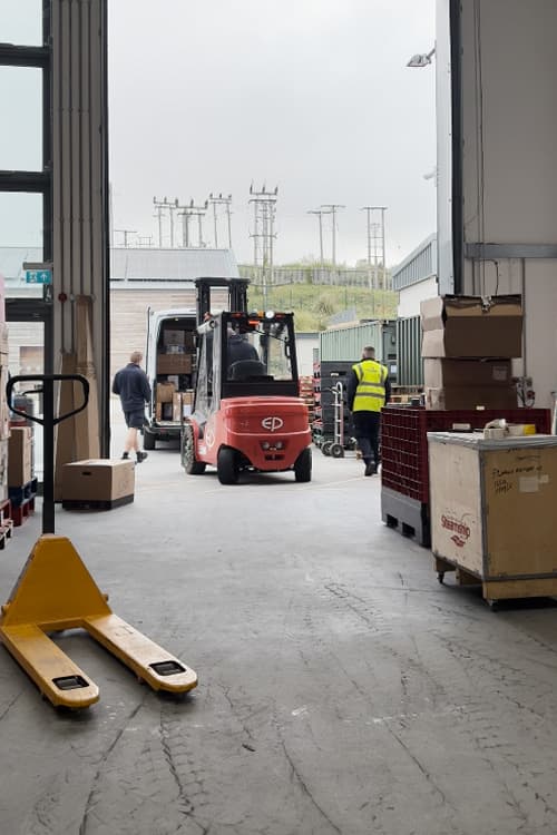 Hayle warehouse team unloading a courier van with a forklift truck