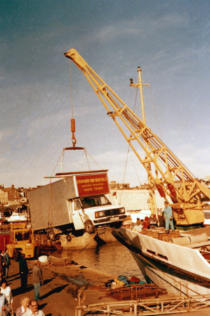 Historic image showing a lorry being loaded onto Scillonian III On Penzance Quay
