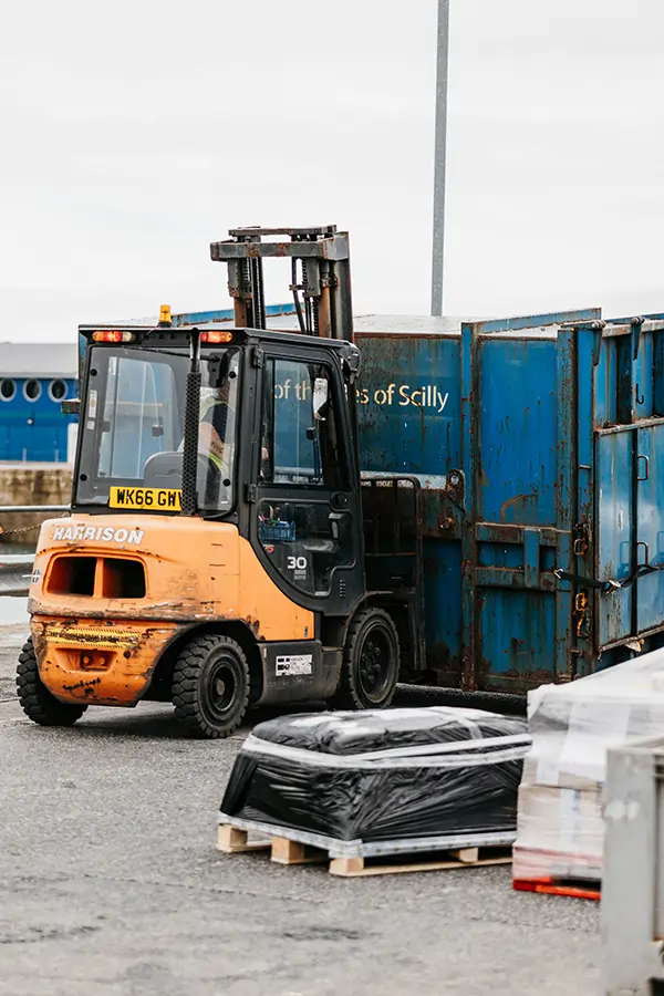 Isles of Scilly Council waste containers being forklifted on Penzance Quay ready for collection
