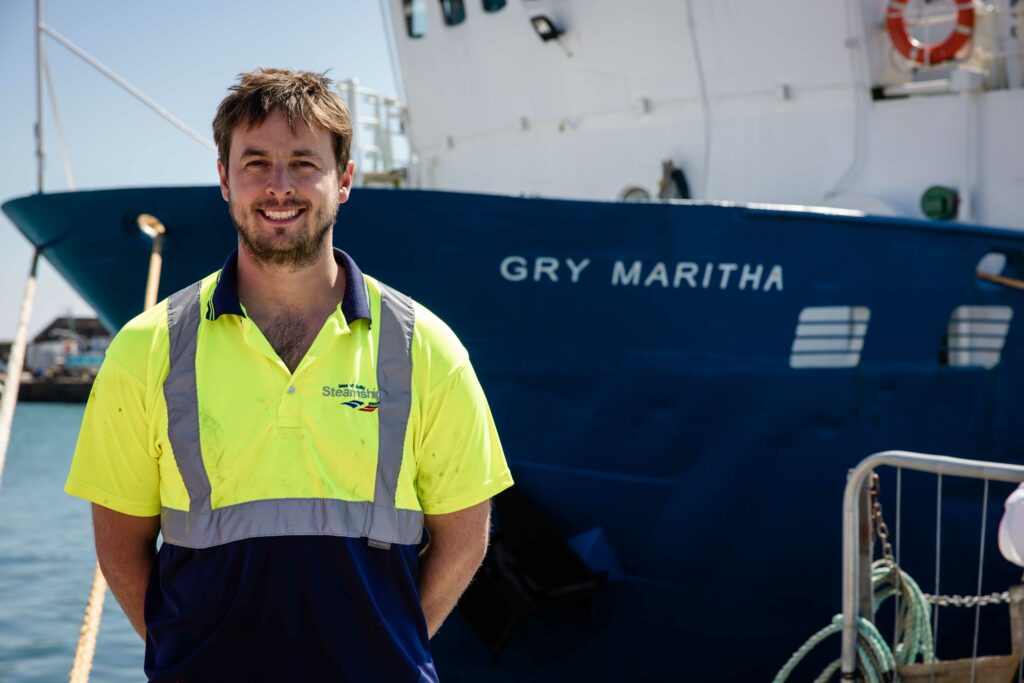 Jon Rundle next to Gry Maritha freight vessel