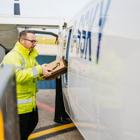 employee loading parcels onto a skybus islander