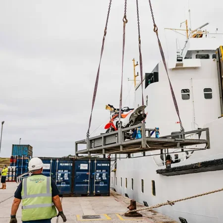 Motor bike being craned onto Scillonian II to be shipped to Penzance - Isles of Scilly Freight