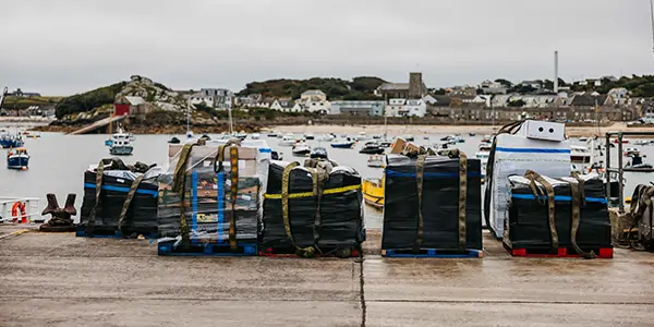 Pallets on St Mary's Quay awaiting collection - Isles of Scilly Freight
