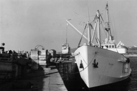 Scillonian II using her crane to unload cargo onto St Mary's Quay, Isles of Scilly