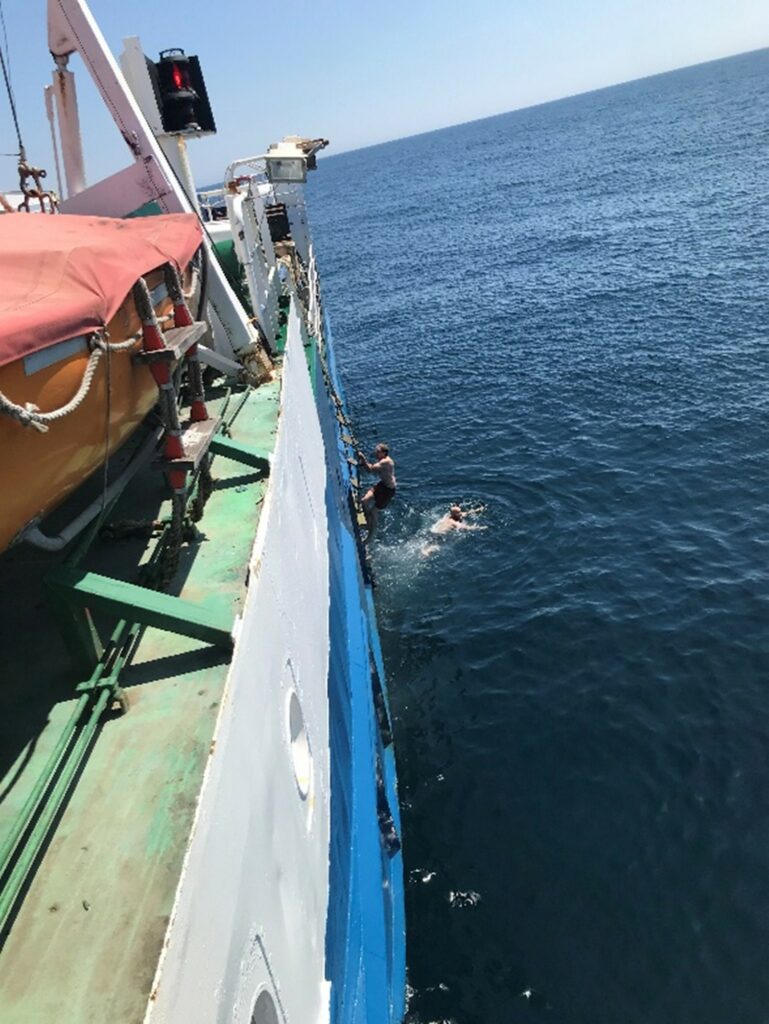 Crew members swimming from Gry Maritha