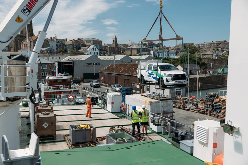 vehicle being loaded by crane on to Menawethan