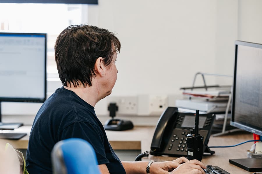 Woman at her desk in the freight office