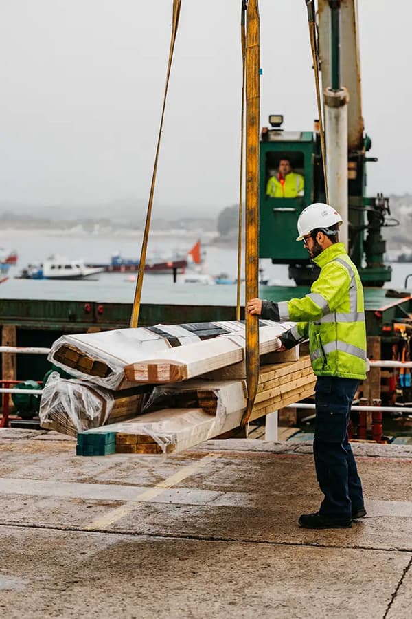 Wood craned off Gry Maritha on to St Mary's quay